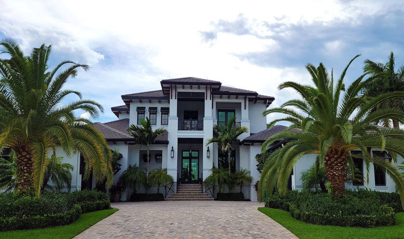 Florida waterfront home with palm trees